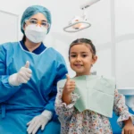 Happy child patient with the dentist after a dental check-up